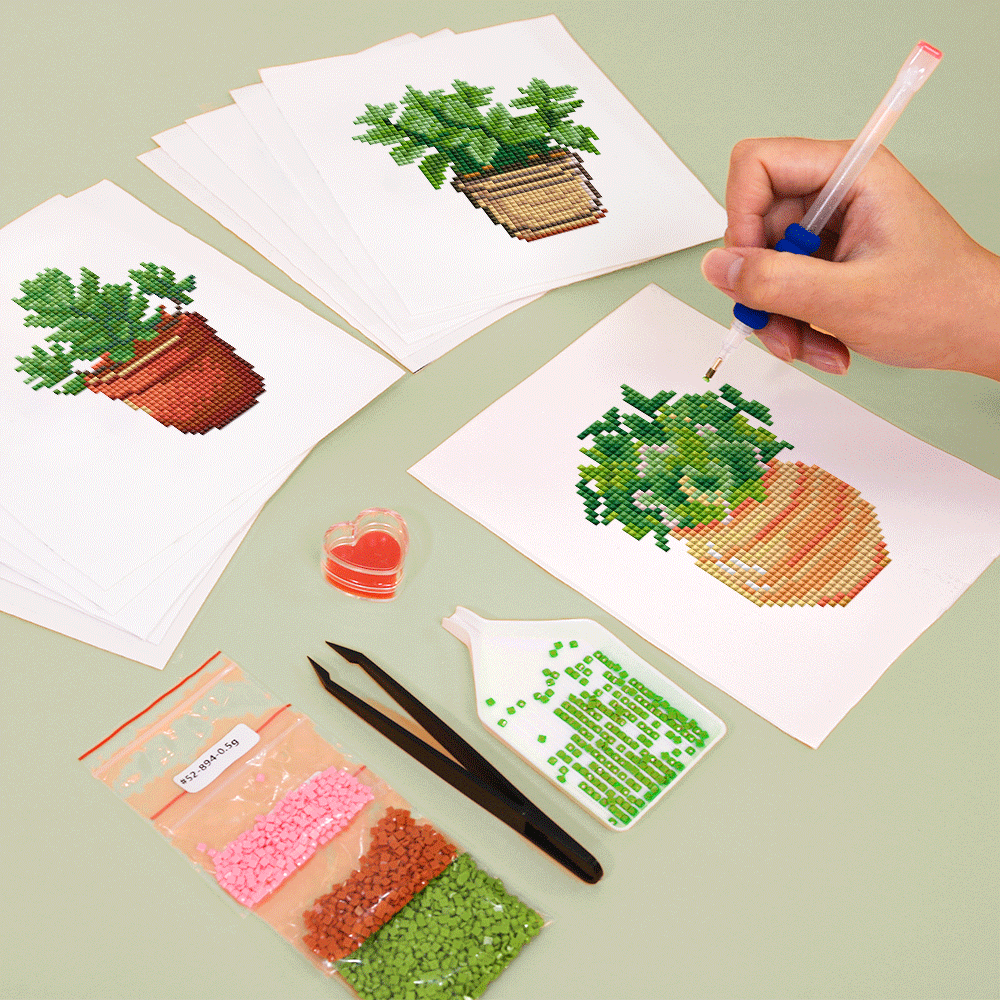 Hands working on succulent and cactus diamond canvases with DIY toolset – relaxing step-by-step activity.