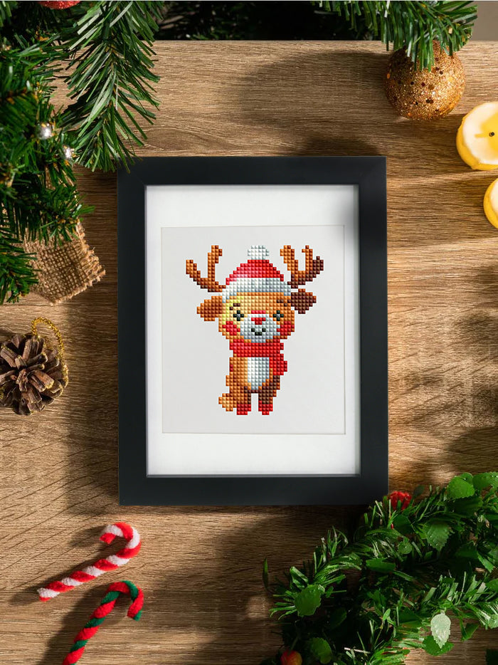 Framed reindeer diamond painting hanging on a Christmas tree, surrounded by ornaments. A joyful festive touch and perfect for beginner crafters.