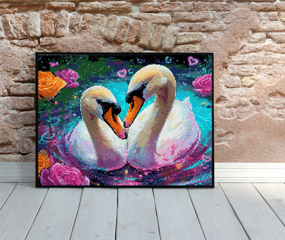 Framed swan diamond painting placed on wooden floor against a rustic brick wall, showcasing vivid colors and serene romantic vibes.