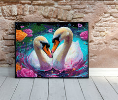 Framed swan diamond painting placed on wooden floor against a rustic brick wall, showcasing vivid colors and serene romantic vibes.