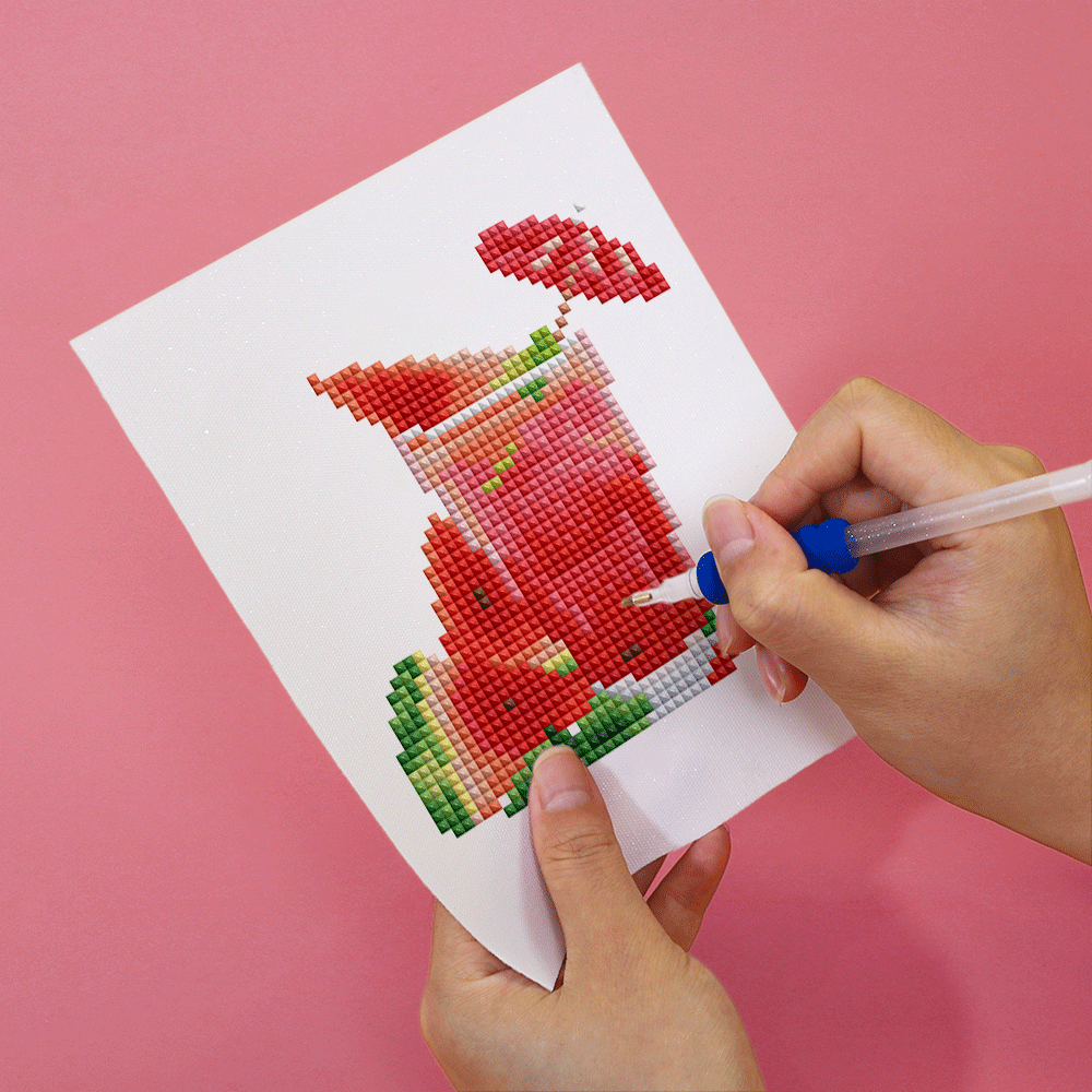 DIY diamond painting of a refreshing watermelon drink on canvas in progress, ideal for creative summer activities and decor.
